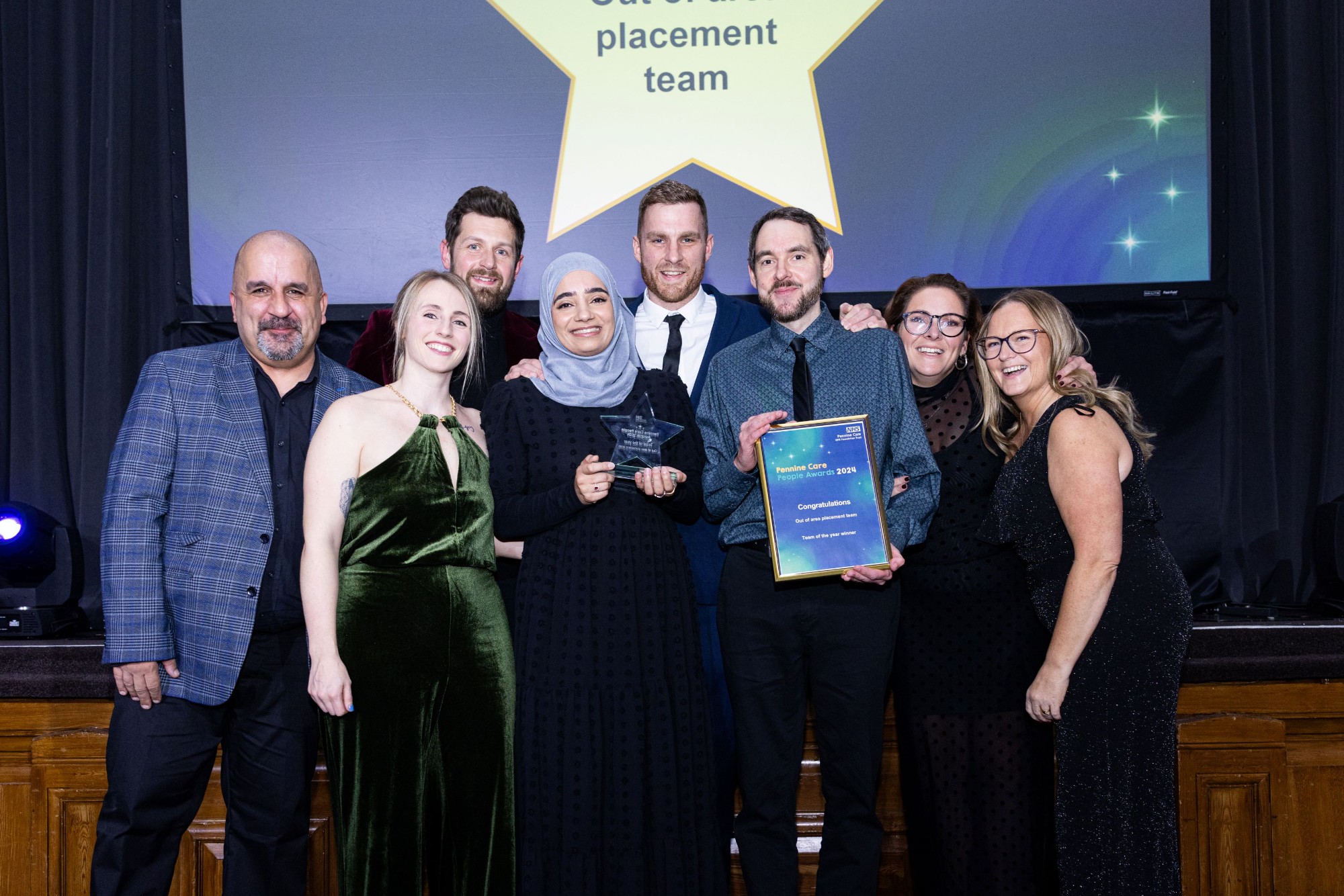 Photo of award winning team with certificate and trophy