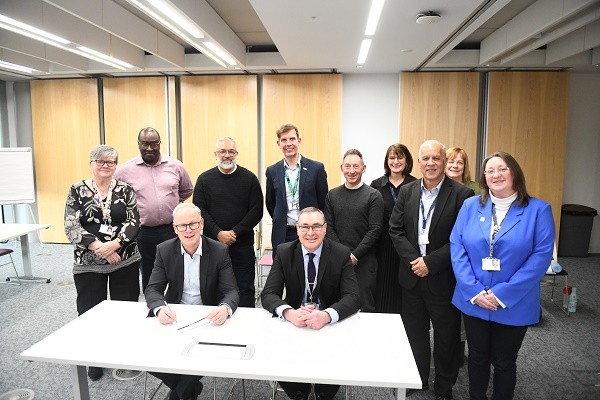 Representatives of Rochdale health and care organisations after signing a local partnership agreement.jpg
