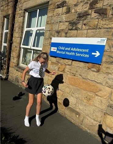 Halle with football at CAMHS.jpg