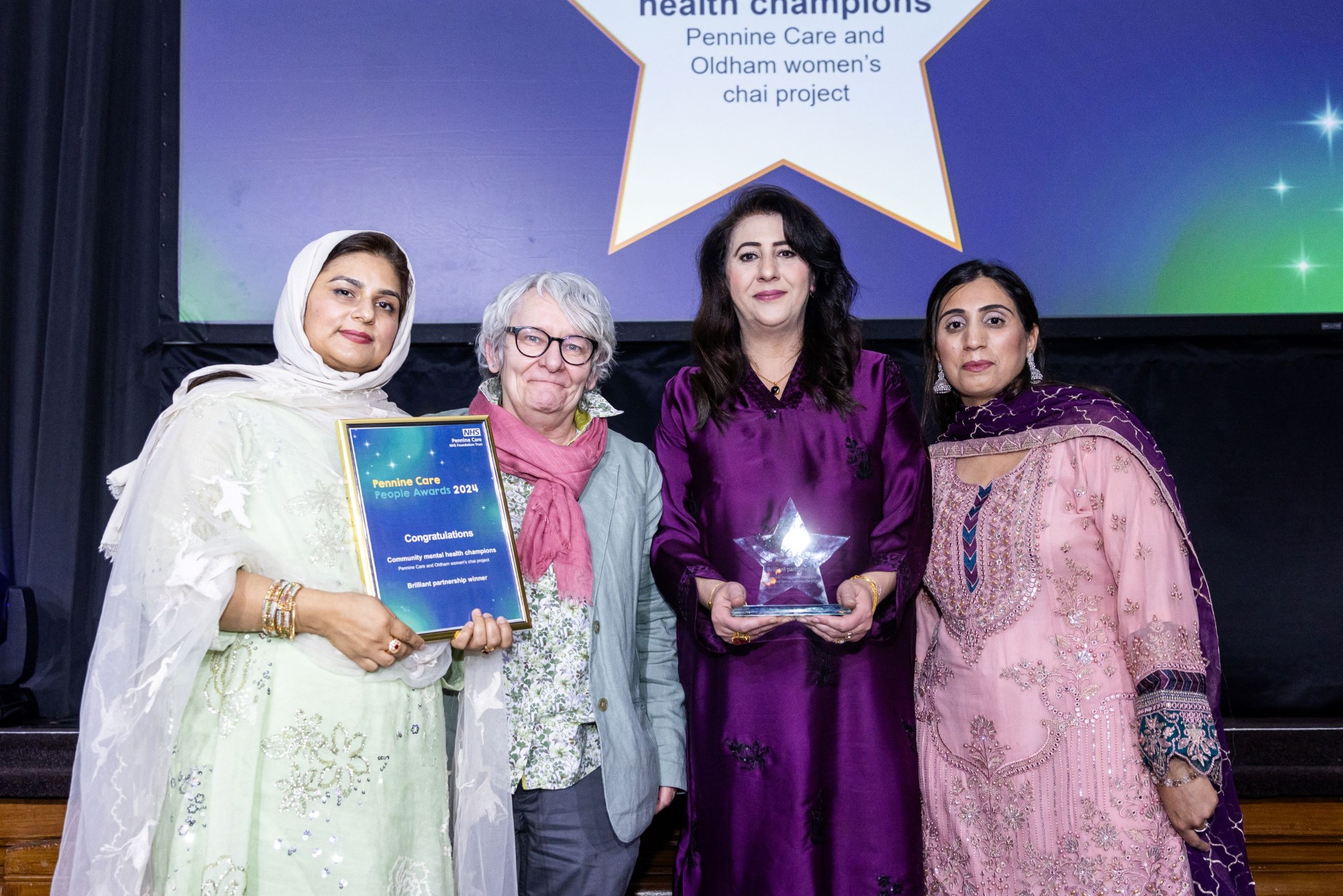 Photo of award winners with trophy and certificate