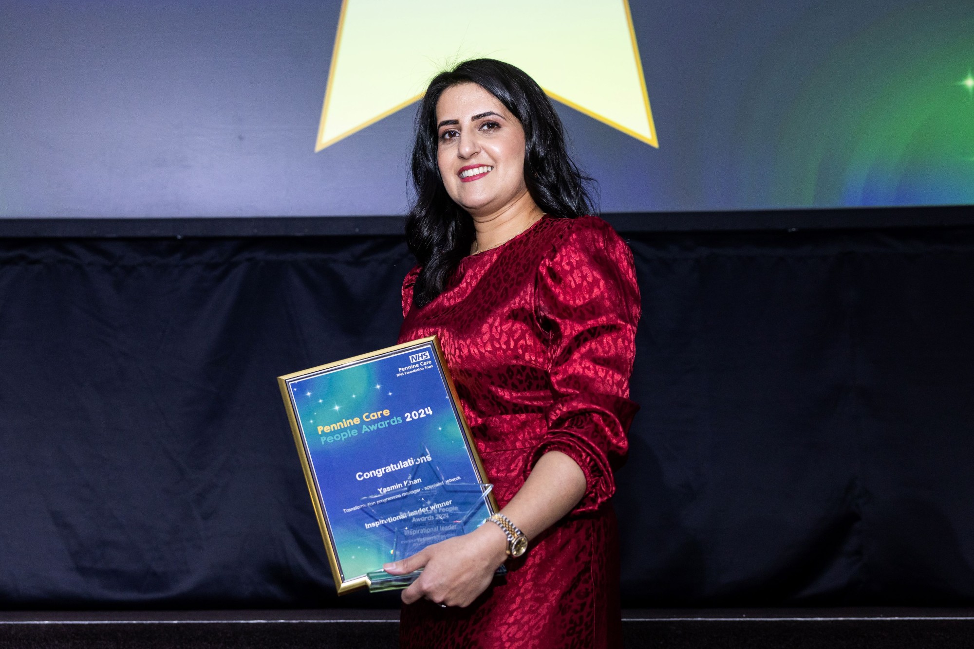 Photo of award winner Yasmin Khan with certificate