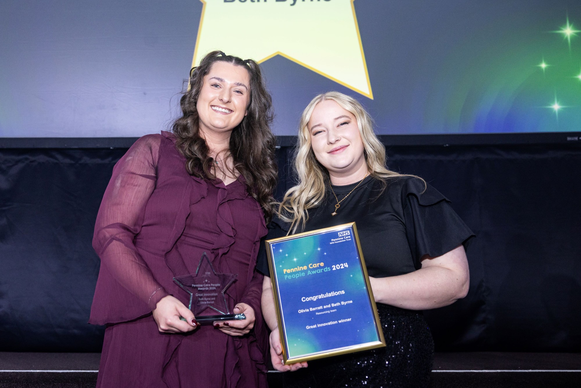 Photo of award winners with certificate and trophy