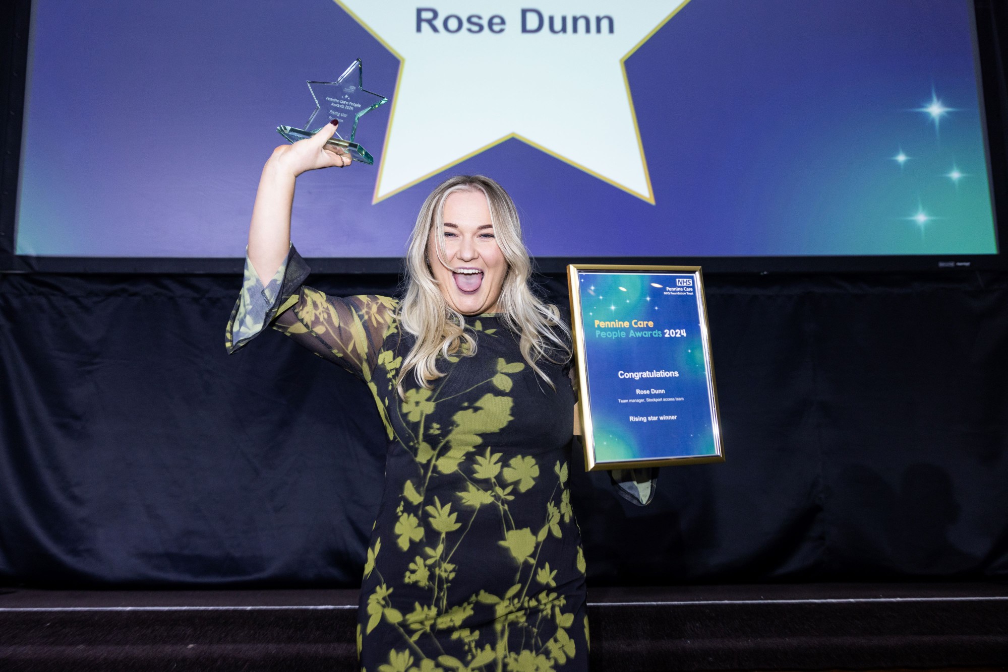 Photo of award winner with certificate and trophy